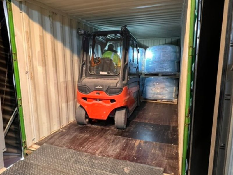 Gabelstapler im Container mit Paletten.